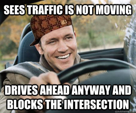 sees traffic is not moving drives ahead anyway and blocks the intersection  SCUMBAG DRIVER