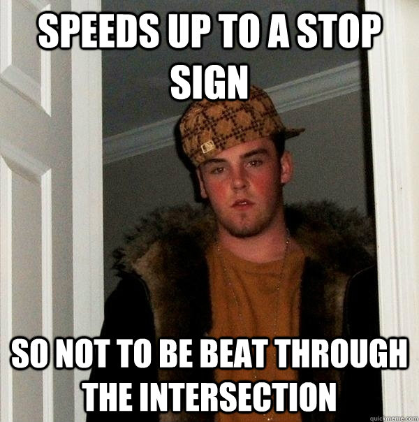 Speeds up to a stop sign So not to be beat through the intersection  