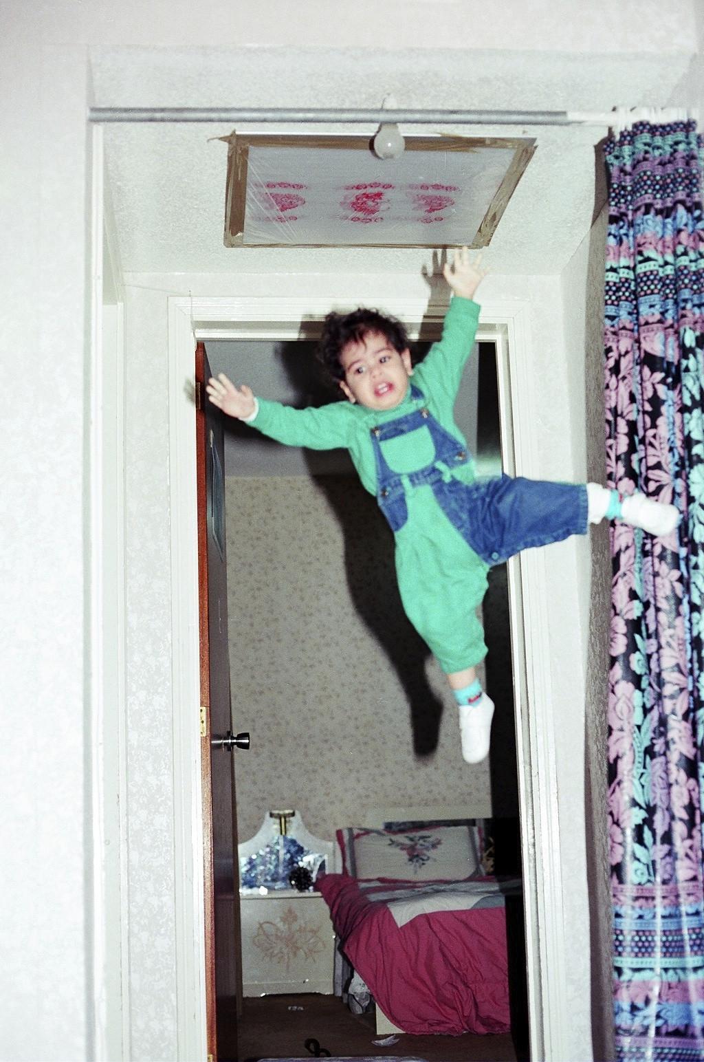 My dad thought 2-year-old me was strong enough to hang from the curtain rod while he takes a picture -   Misc