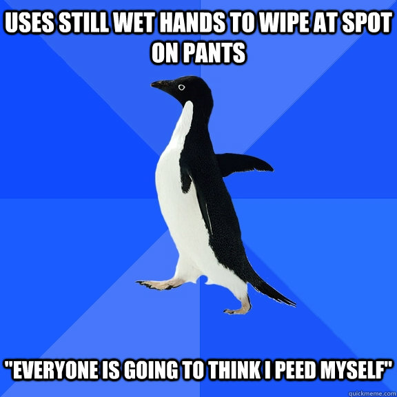 Uses still wet hands to wipe at spot on pants   