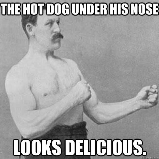 The hot dog under his nose looks delicious.  overly manly man