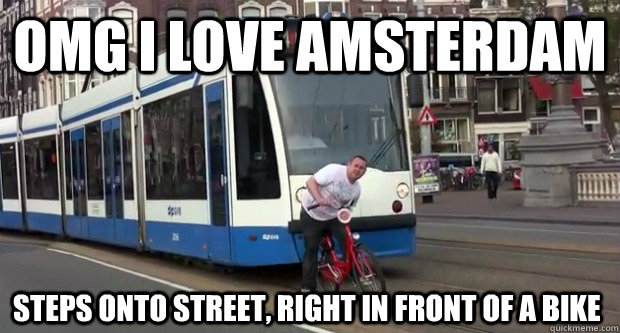 OMG I love Amsterdam steps onto street, right in front of a bike  