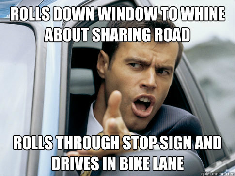 rolls down window to whine about sharing road rolls through stop sign and drives in bike lane  Asshole driver