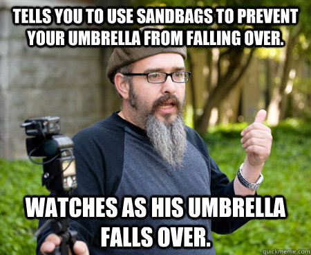 Tells you to use sandbags to prevent your umbrella from falling over. Watches as his umbrella falls over.  