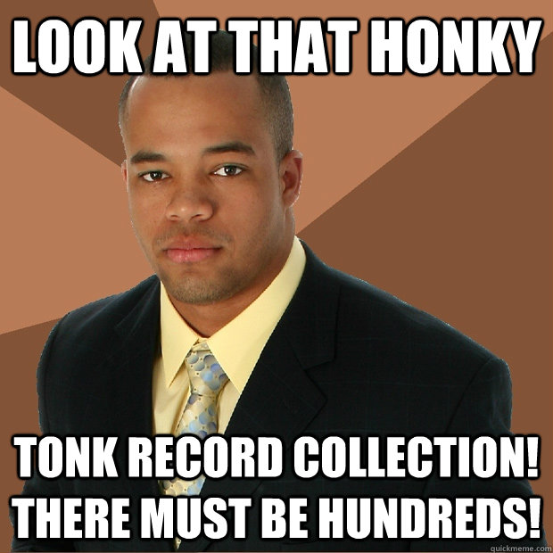 look at that honky tonk record collection! there must be hundreds!  Successful Black Man