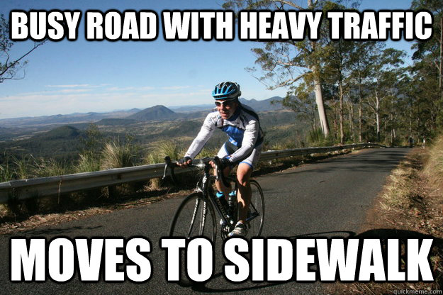 Busy road with heavy traffic moves to sidewalk  