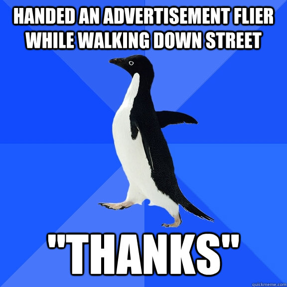 handed an advertisement flier while walking down street 