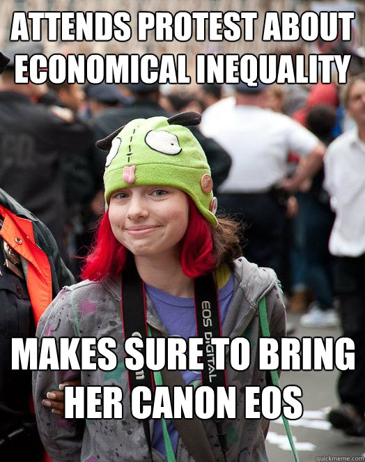 Attends protest about economical inequality Makes sure to bring her Canon eos  