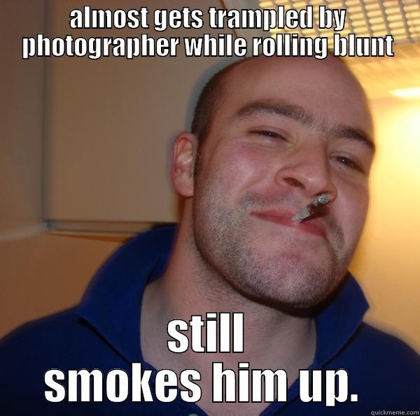 ALMOST GETS TRAMPLED BY PHOTOGRAPHER WHILE ROLLING BLUNT STILL SMOKES HIM UP.  Good Guy Greg 