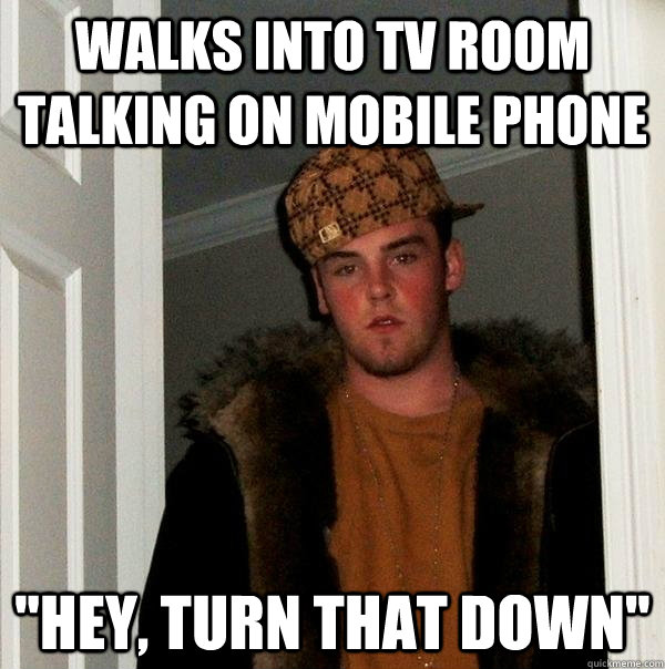 Walks into TV room talking on mobile phone 