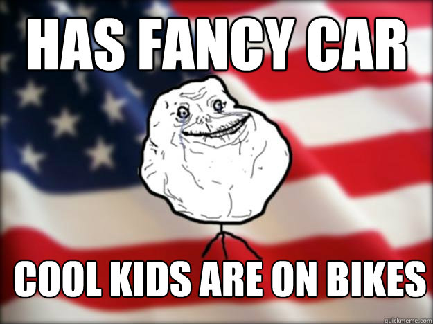 Has fancy car cool kids are on bikes  