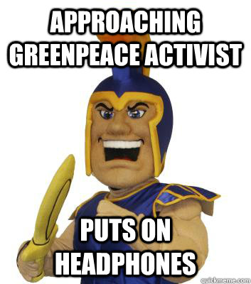 approaching Greenpeace activist puts on headphones   