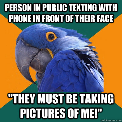 Person in public texting with phone in front of their face 