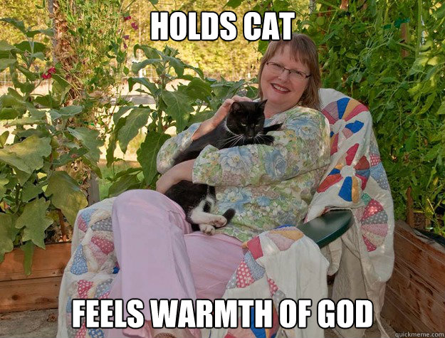 Holds cat Feels warmth of god  