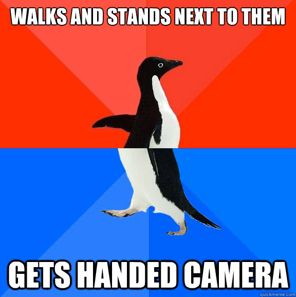 Walks and stands next to them  gets handed camera  Awesome Awkward Penguin
