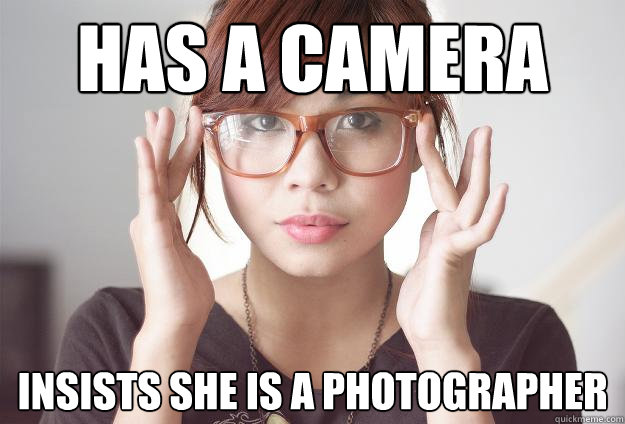 Has a camera insists she is a photographer  Hispter Traveler