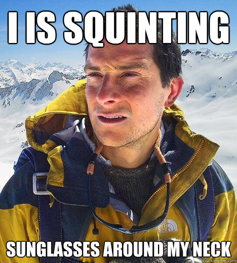 I IS SQUINTING sunglasses around my neck  Bear Grylls