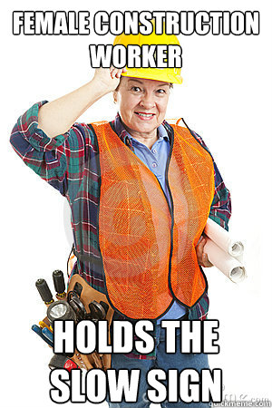 Female Construction Worker Holds the Slow sign  