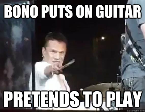 Bono puts on guitar pretends to play  