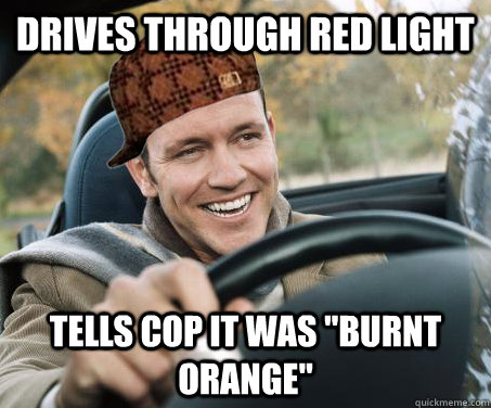 Drives through red light tells cop it was 