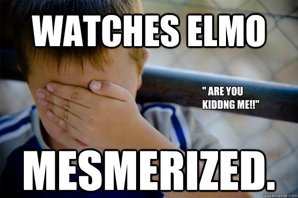 watches elmo mesmerized. 