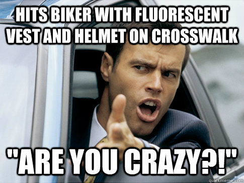 hits biker with fluorescent vest and helmet on crosswalk 