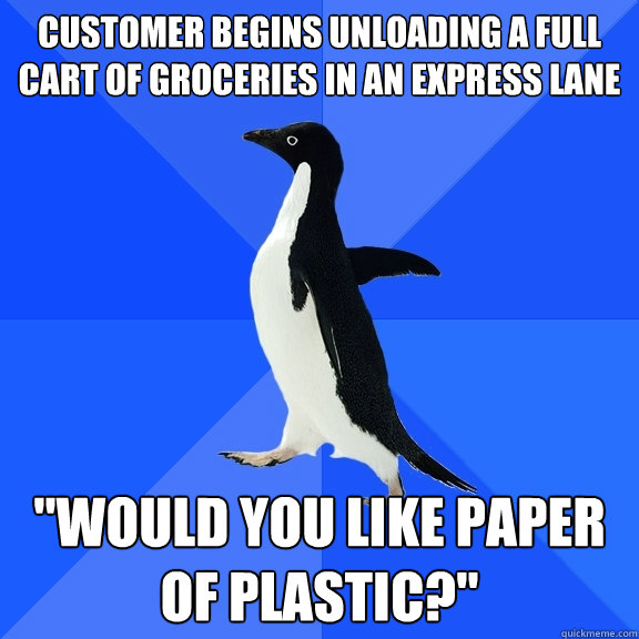 Customer begins unloading a full cart of groceries in an express lane 