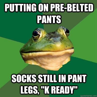 putting on pre-belted pants socks still in pant legs, 