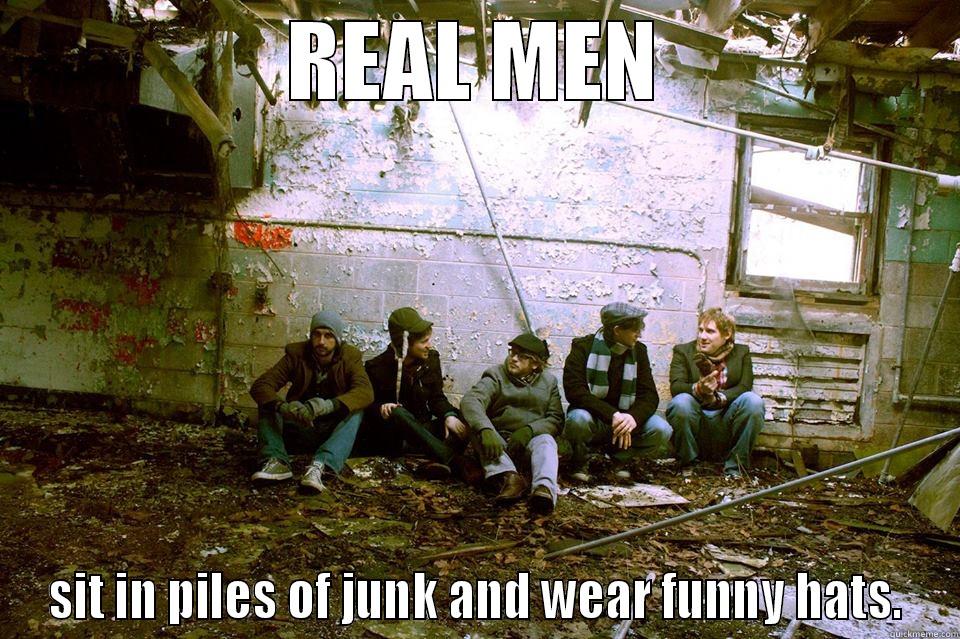 REAL MEN SIT IN PILES OF JUNK AND WEAR FUNNY HATS. Misc