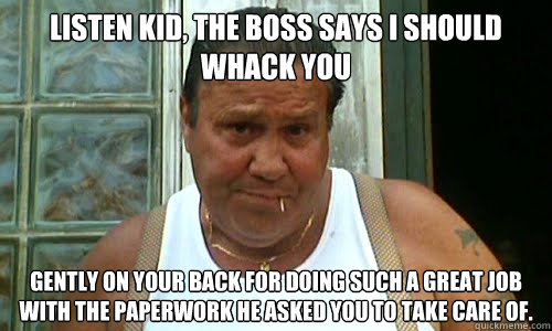 Listen kid, the boss says I should whack you gently on your back for doing such a great job with the paperwork he asked you to take care of.  - Listen kid, the boss says I should whack you gently on your back for doing such a great job with the paperwork he asked you to take care of.   Non Mafia Italian