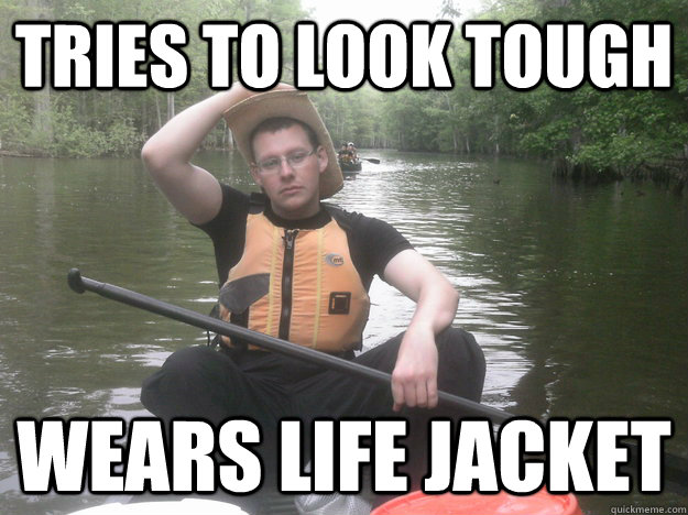tries to look tough wears life jacket  