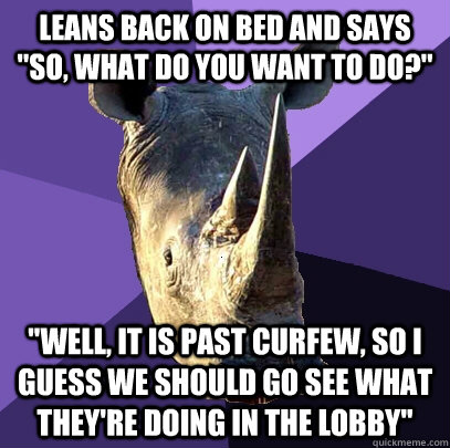 Leans back on bed and says 