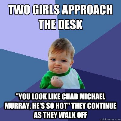 two girls approach the desk 