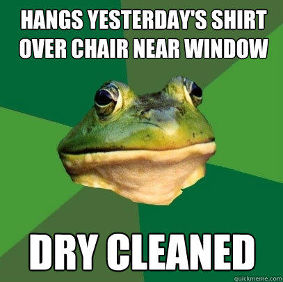hangs yesterday's shirt over chair near window dry cleaned  