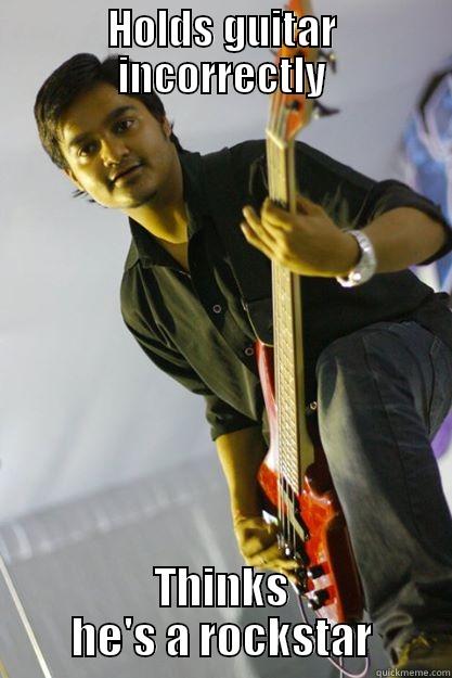 HOLDS GUITAR INCORRECTLY THINKS HE'S A ROCKSTAR Misc