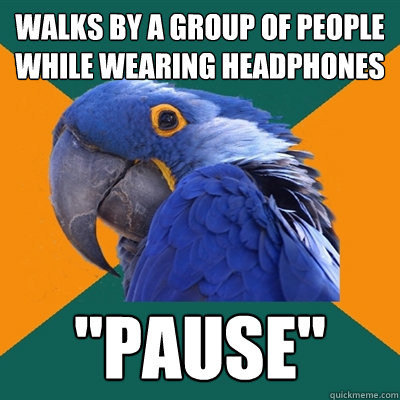 walks by a group of people while wearing headphones 